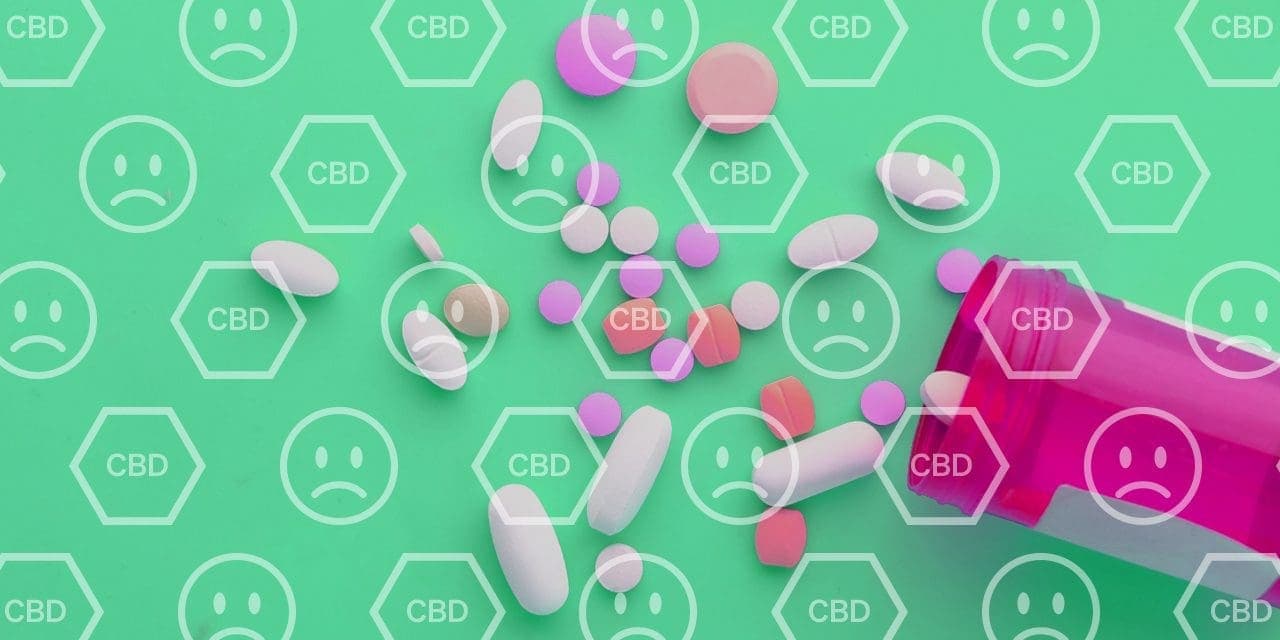 tumbled pink pill container exposing different kinds of medicine pills